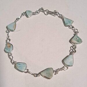 blue and white stone design bead on a silver color metal chain bracelet